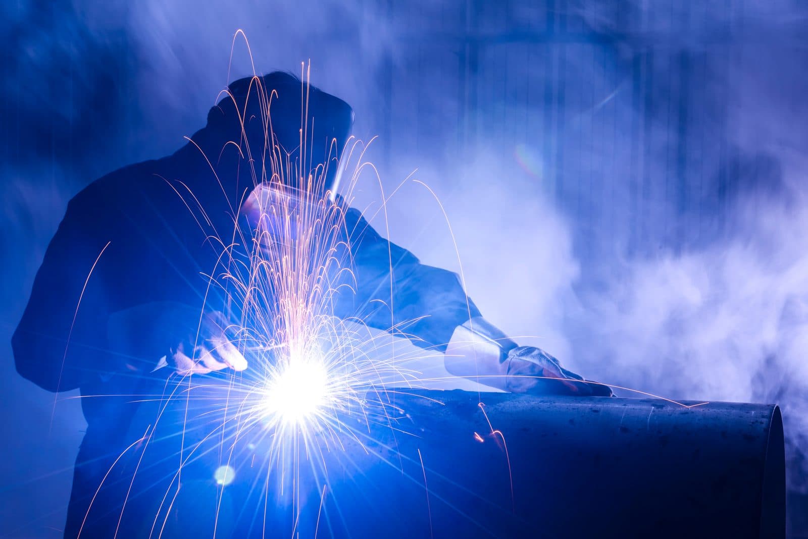 Industrial crew working a steel pipe assembly