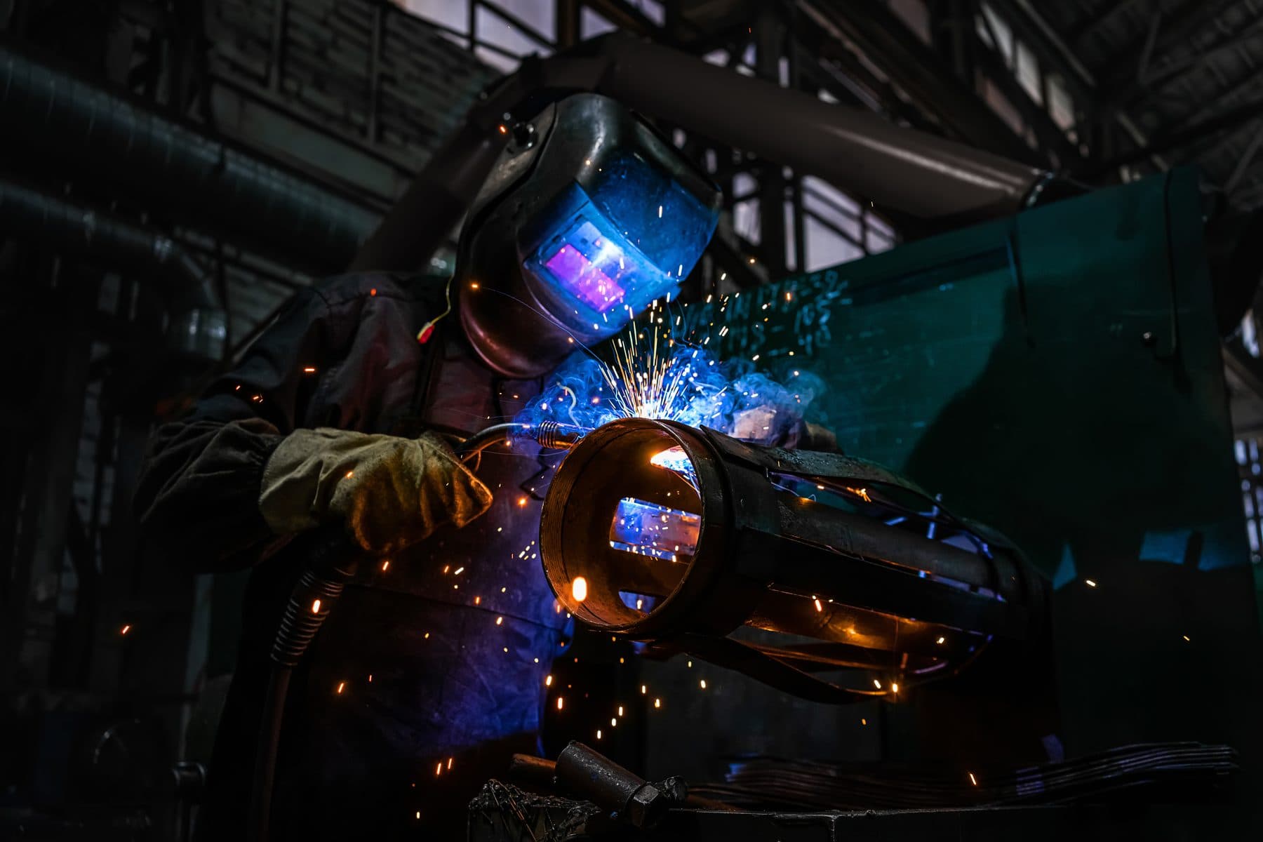 Industrial welder striking structural steel with sparks flying, 757 Welding