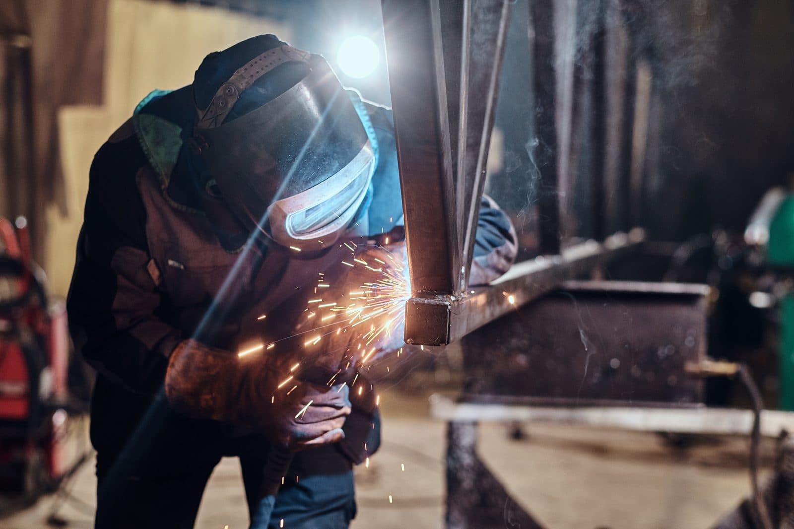 Welder fabricating custom metal work in the shop